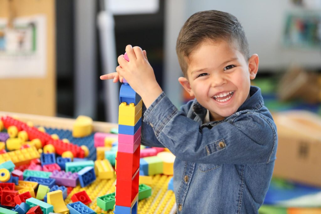 Student posing with building blocks