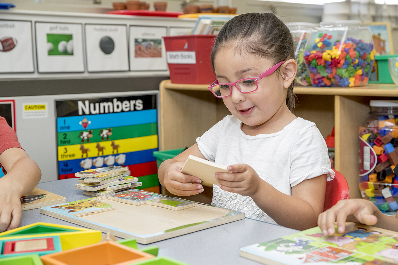 girl in class completing a puzzle